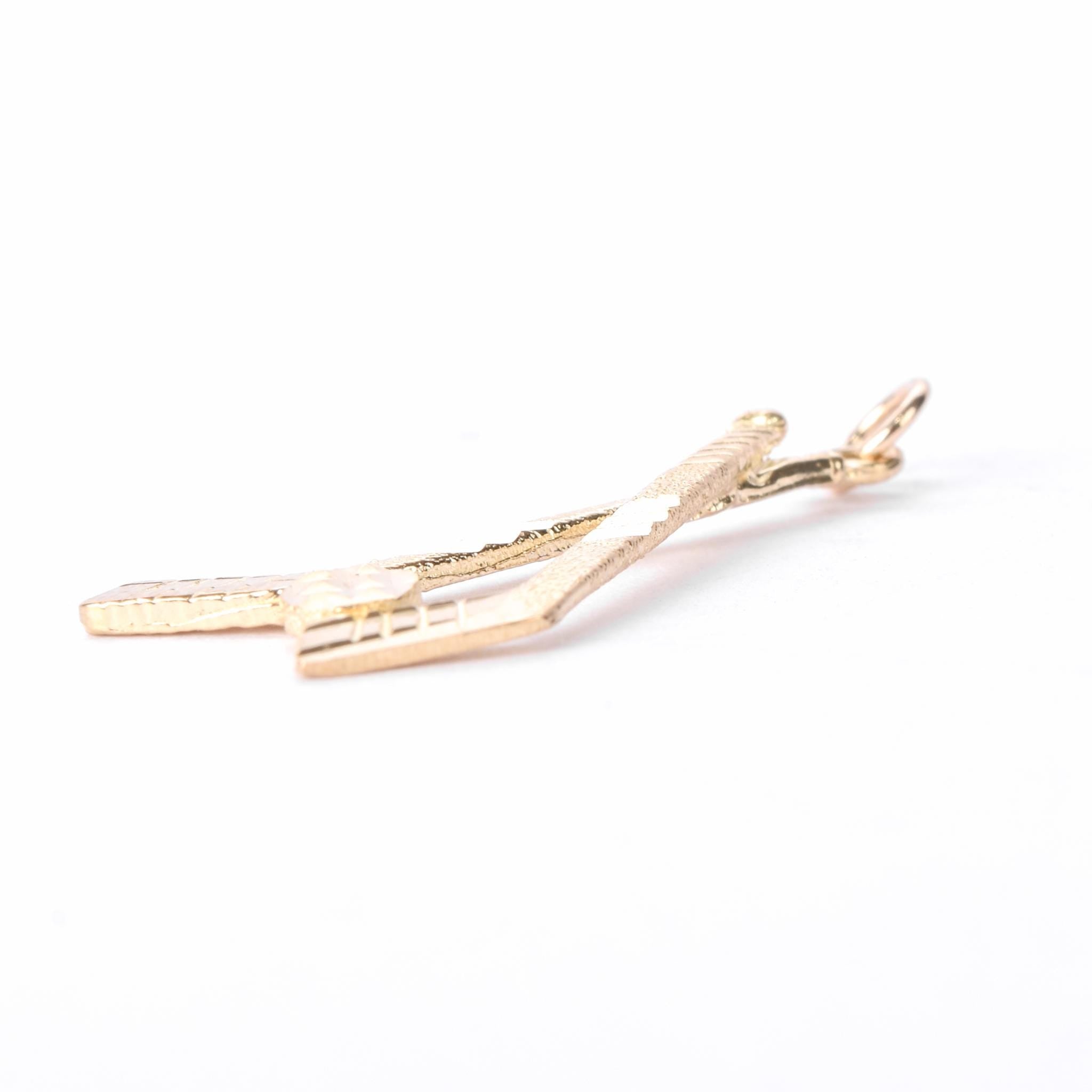 10K Gold Hockey Sticks and Puck Pendant