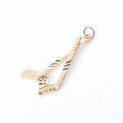 10K Gold Hockey Sticks and Puck Pendant