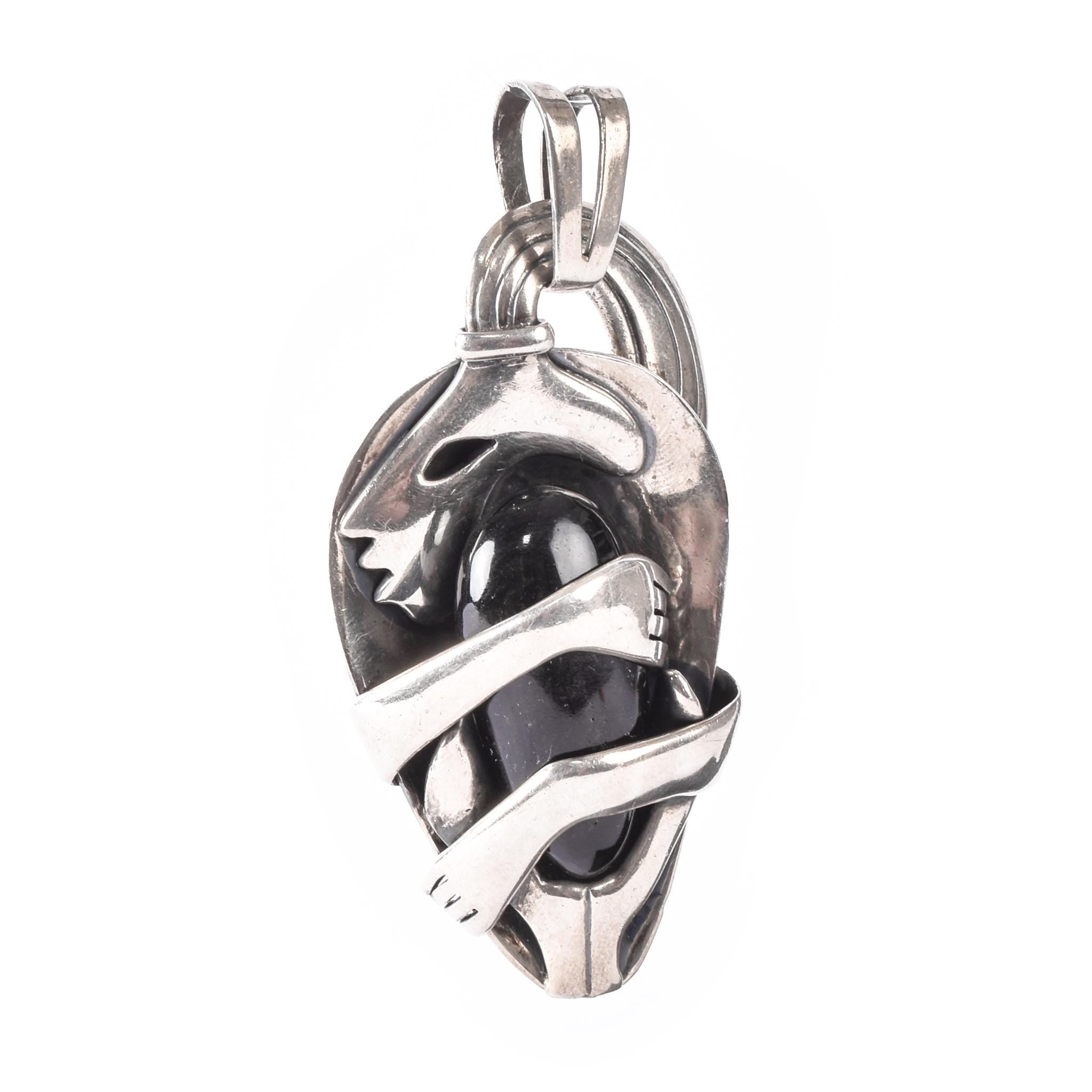 Sterling Silver Mexican Diety Hugging an Onyx Pendant