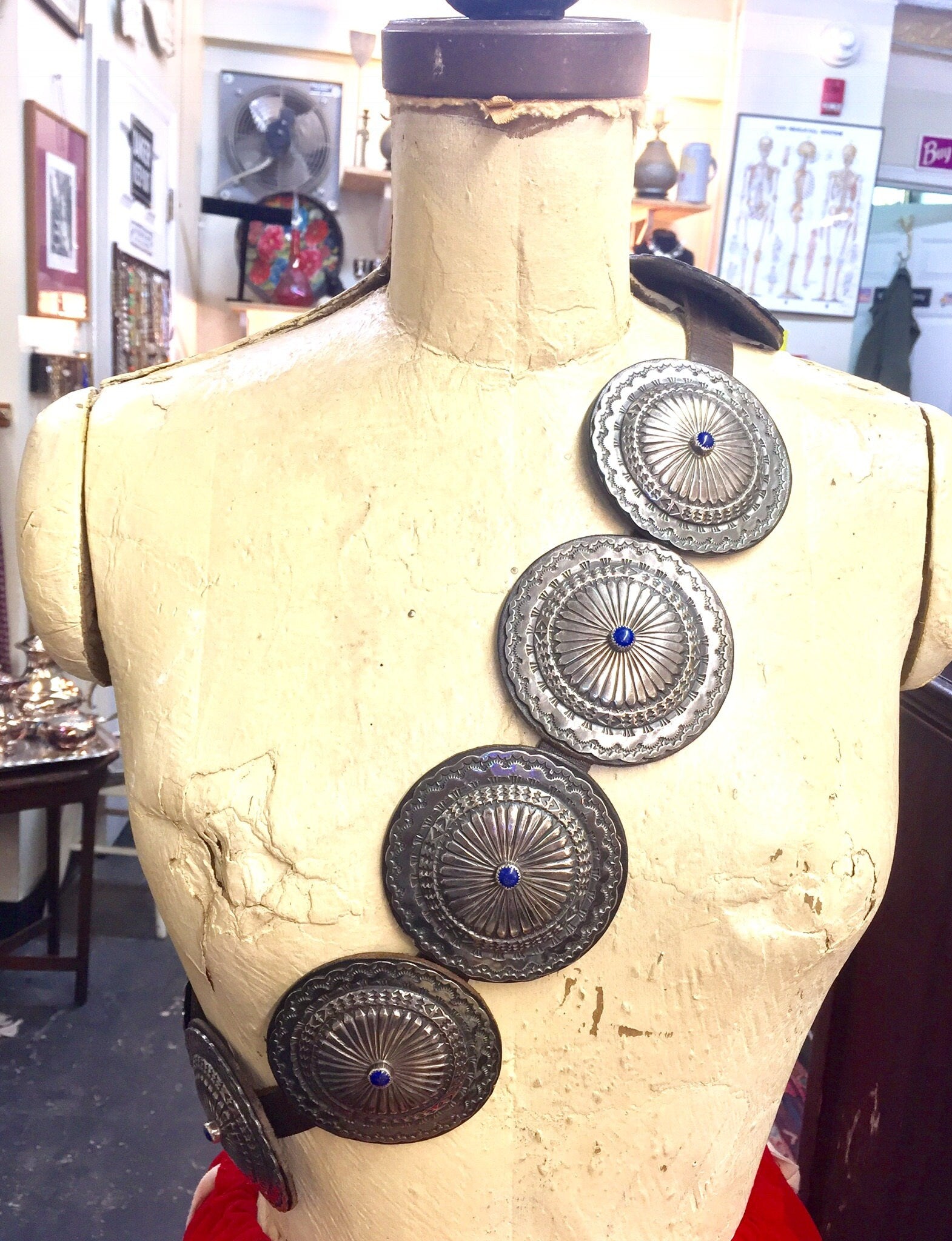 Vintage Navajo handmade sterling silver concho belt with lapis stone accents on leather, Native American southwestern style accessory on dress form mannequin in antique store