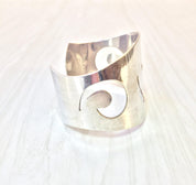 Vintage sterling silver cuff bracelet featuring a swirl design by Reed & Barton, a beautiful piece of silver jewelry that makes an elegant gift.