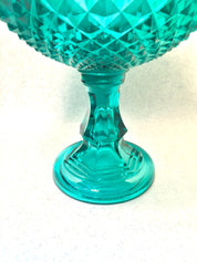 Vintage aqua green cut glass lidded pedestal compote bowl with sawtooth pattern on a white background