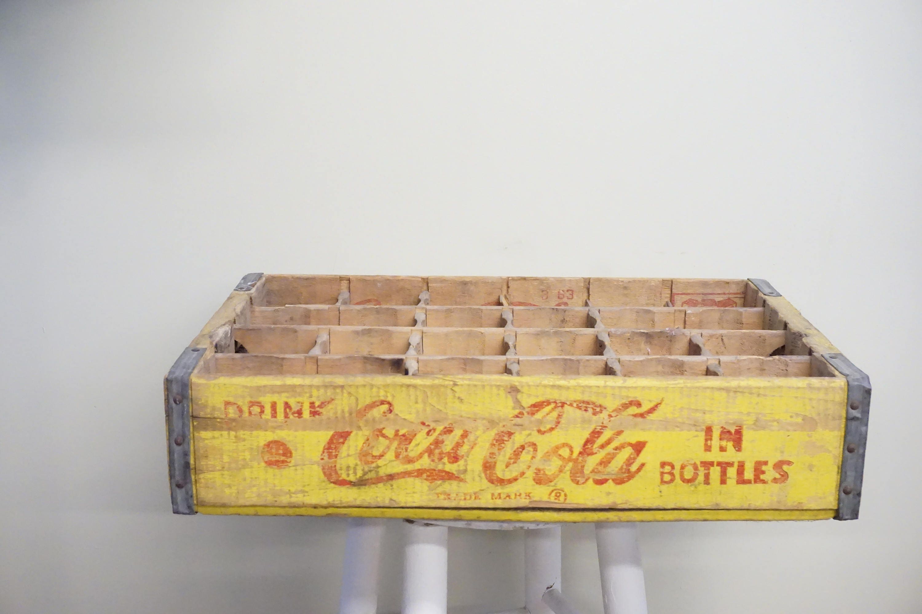Vintage yellow wooden Coca-Cola bottle crate with 24 bottle compartments