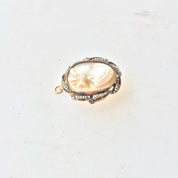 10 karat gold vintage carved shell cameo brooch or pendant necklace against a plain white background