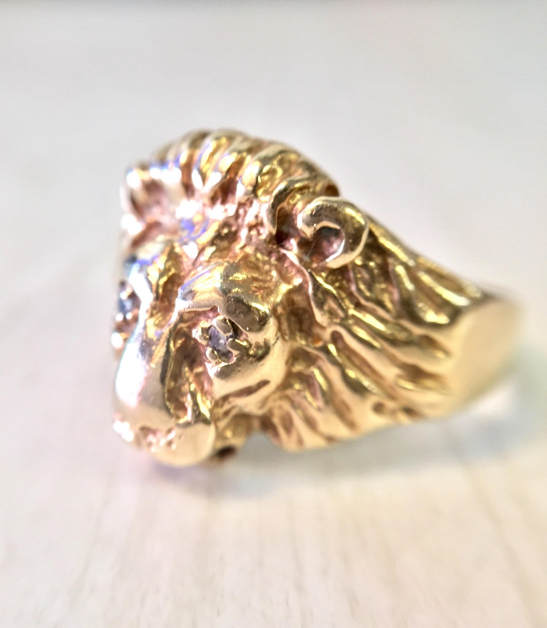 Vintage 10K gold lion head ring with diamond accents, featuring intricate detailing on the lion's mane and a bold, statement-making design from the retro era.