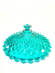 Aqua green cut glass covered pedestal compote bowl with sawtooth pattern and ornate lid, made of depression glass by Indiana Glass, ideal for home decor or as a gift.