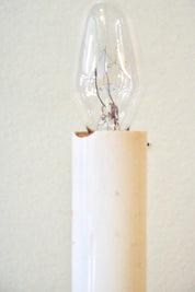 Vintage brass pineapple lamp illuminated against a plain background, providing warm ambient lighting with a bohemian accent suitable for home decor or as a unique gift.