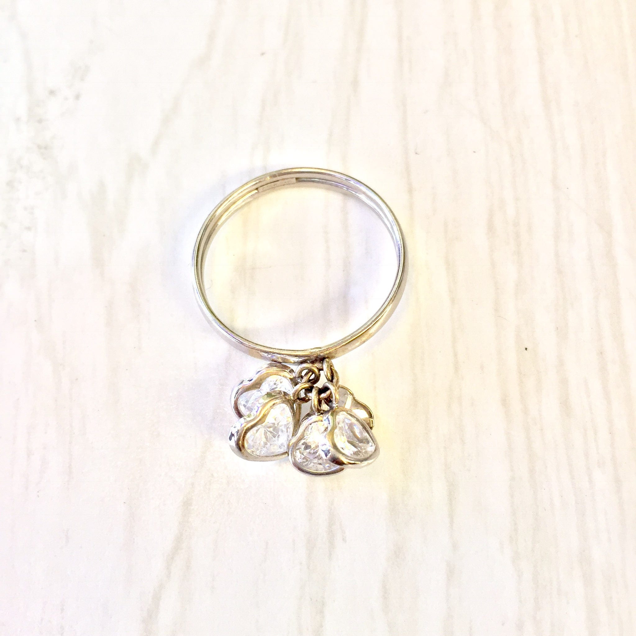 14K white gold ring with dangling cubic zirconia hearts, a charming holiday gift idea for her