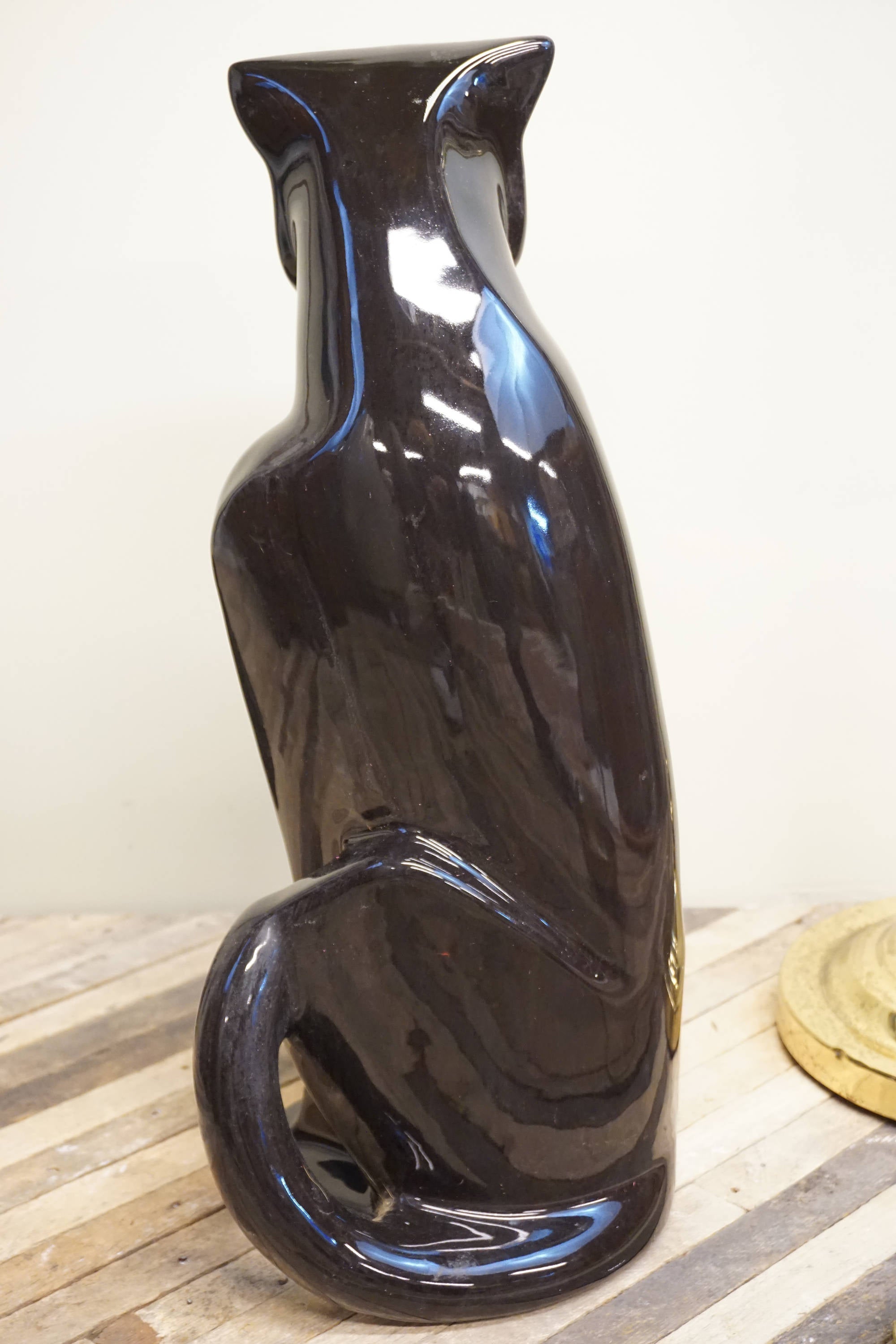 Tall black glazed ceramic Royal Haeger panther statue from the 1970s, vintage home decor piece featuring sleek curves and an elegant pose.