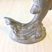 Vintage pewter fish candlestick holder with intricate scale and fin details, making a unique housewarming or holiday gift for antique home decor enthusiasts.