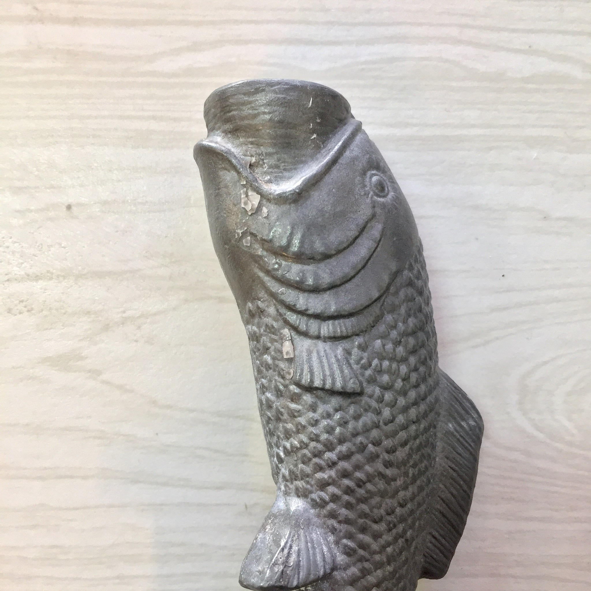 Vintage pewter fish-shaped candlestick holder on wooden surface, antique home decor gift idea