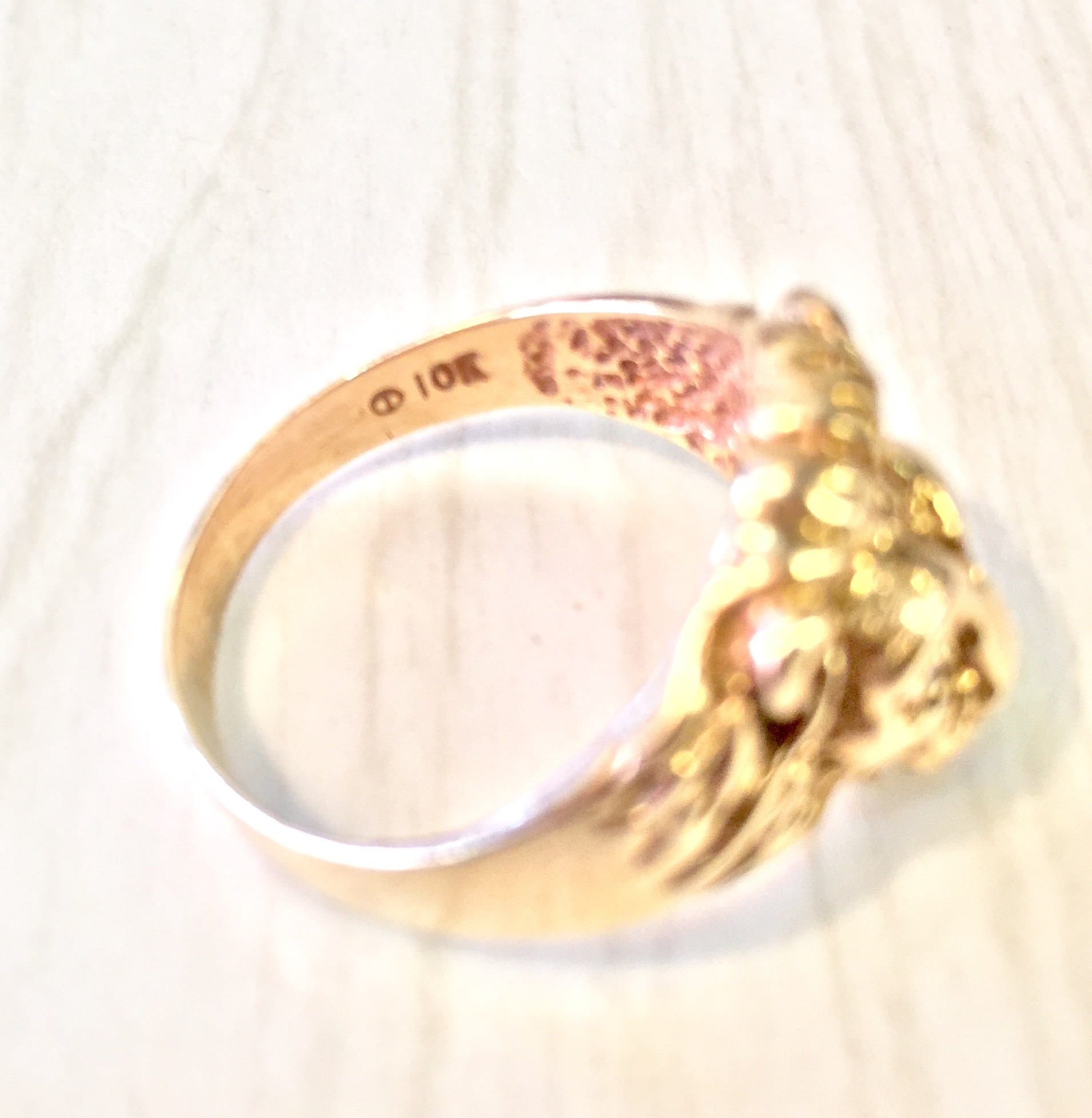 Vintage 10 karat gold lion head ring with diamond accents, showcasing intricate design and craftsmanship in a statement jewelry piece from a bygone era.