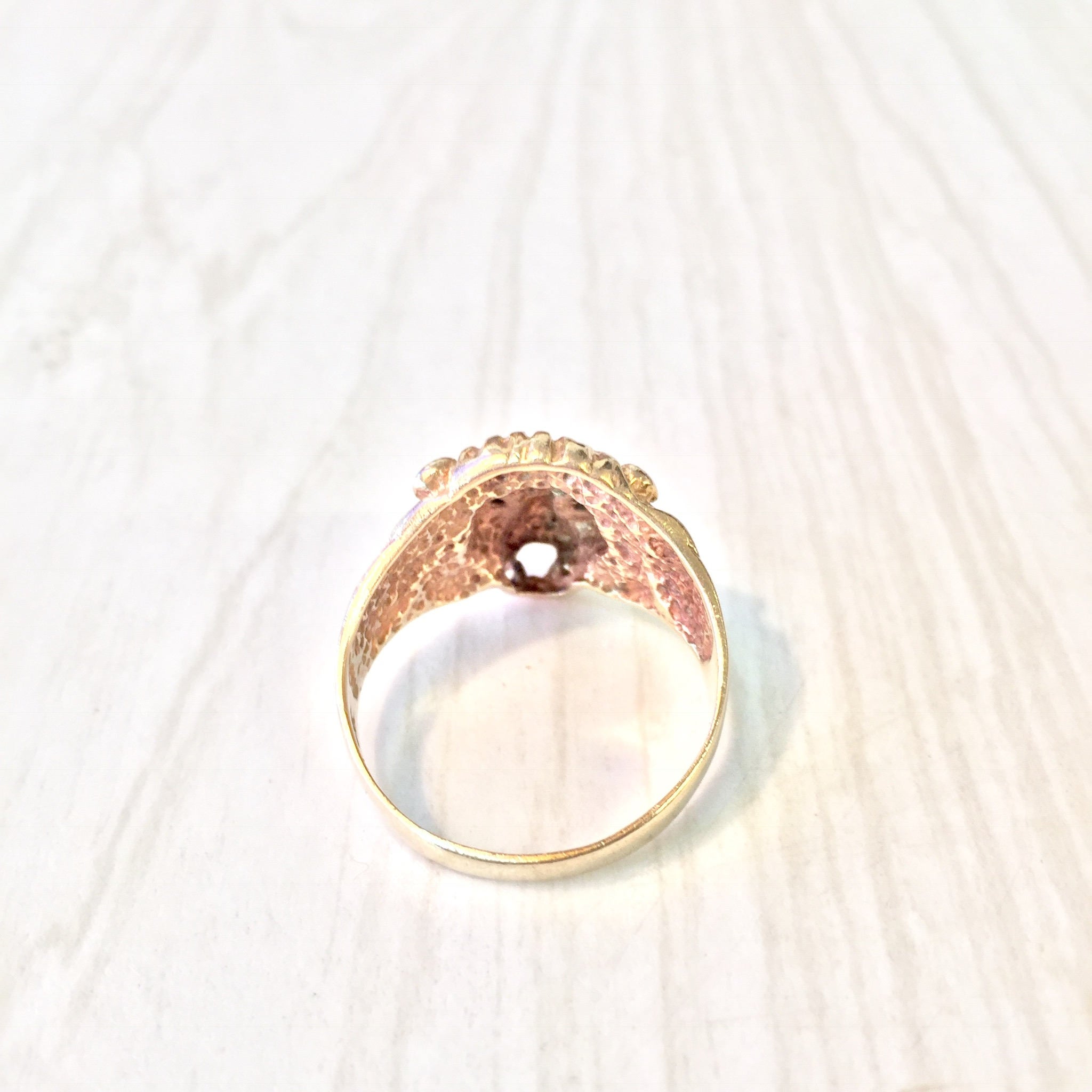 Vintage 10K gold lion's head ring with diamond accents, featuring intricate detailing and a striking statement design from the retro era.