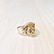 Vintage 10K gold lion head ring with diamond accents, featuring intricate detailing and a bold statement design from the retro era.