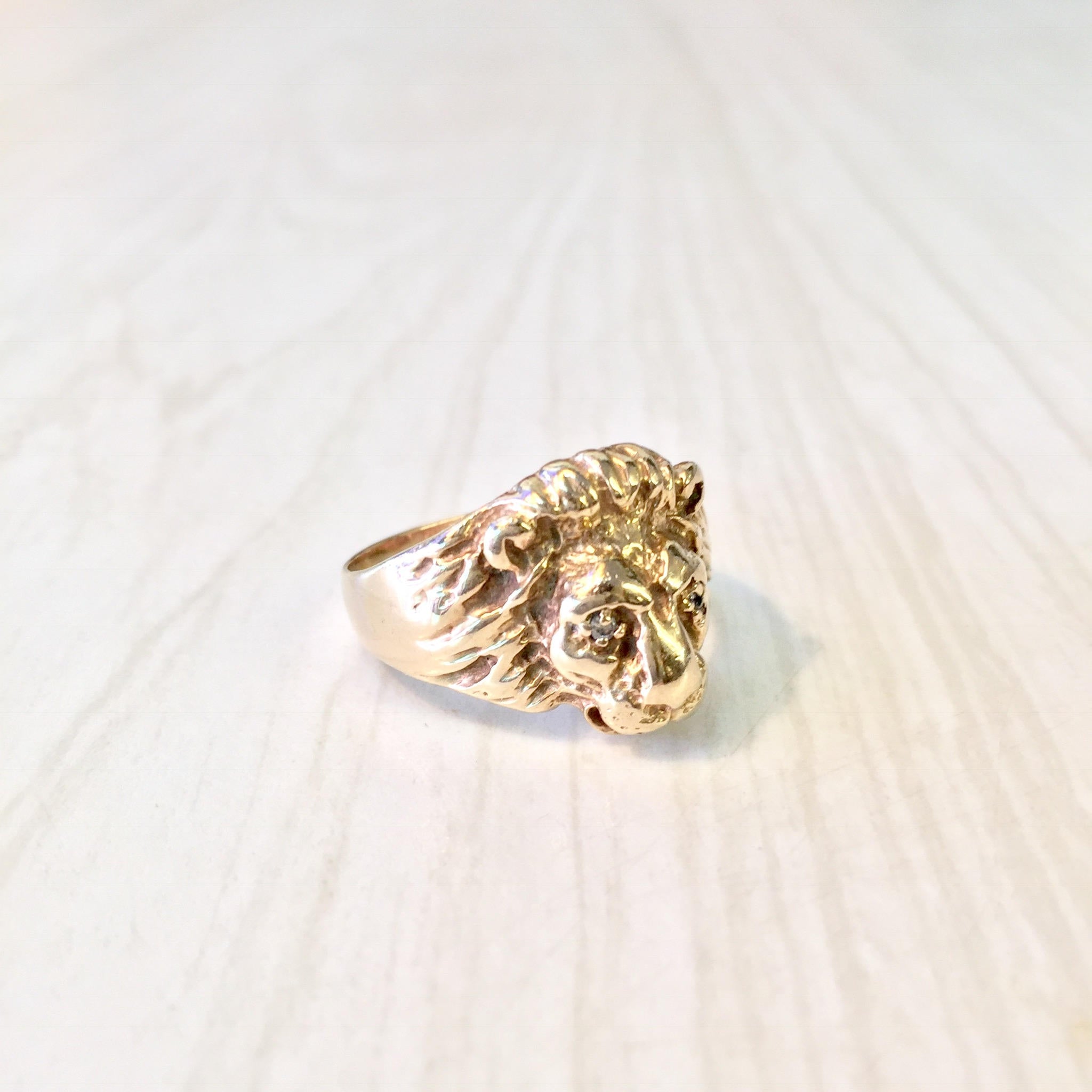 Vintage 10K gold lion head ring with diamond accents, featuring intricate detailing and a bold statement design from the retro era.