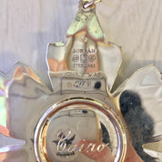 Vintage Gorham Sterling Silver Christmas ornament shaped like a snowflake, with the Gorham logo and "Sterling" engraved on the surface, hanging from a silver ribbon against a light background.