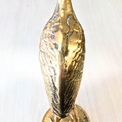 Vintage brass crane statue with detailed feather texture and patina. Midcentury modern style brass bird figurine for home decor.