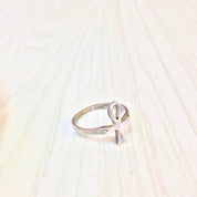 Vintage sterling silver ankh ring on light wooden background