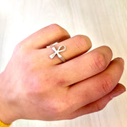 Vintage sterling silver Ankh ring worn on a person's finger, representing Egyptian jewelry and a meaningful gift idea.