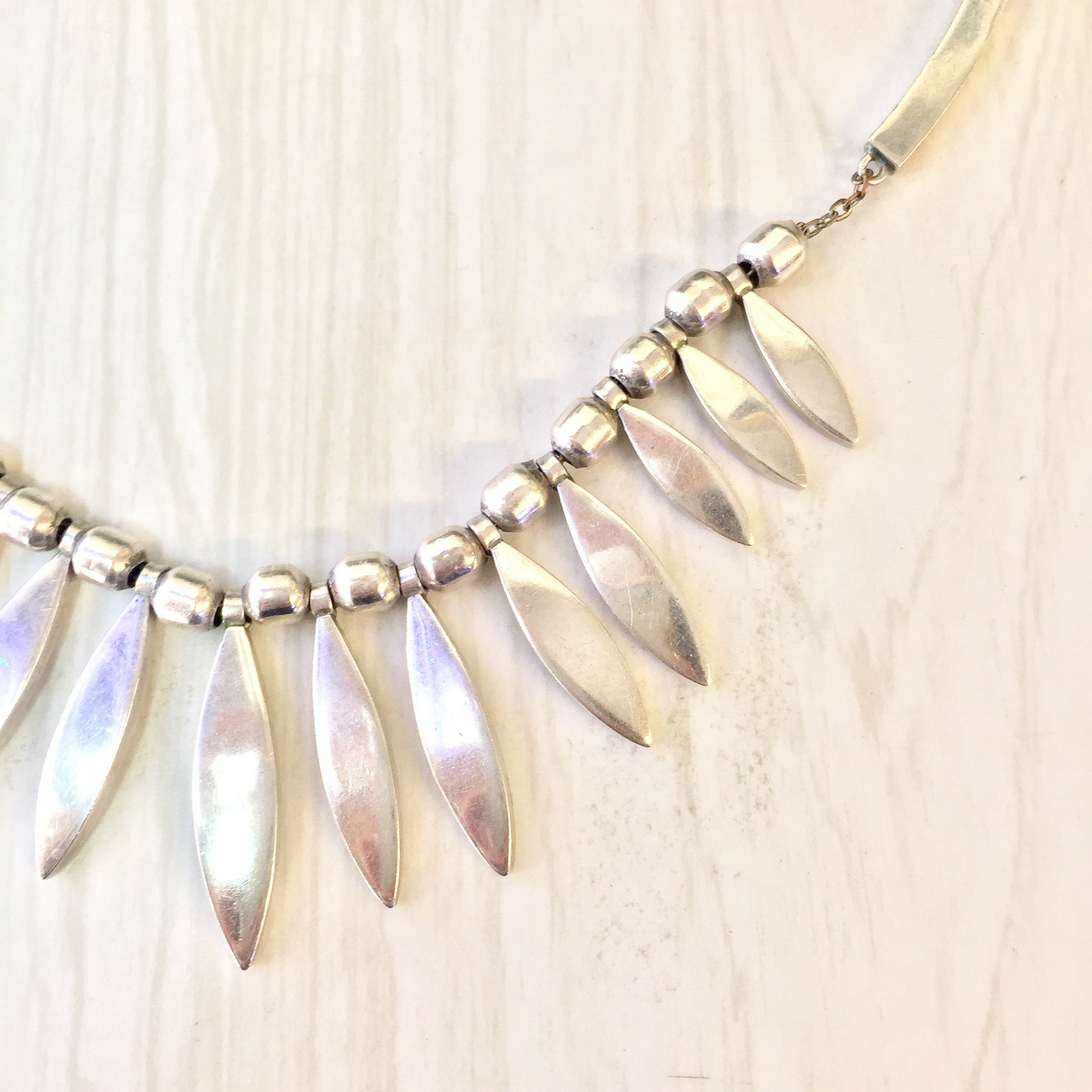 Vintage sterling silver statement necklace with dangling pointed oval charms, creating a bib-style design. Elegant Mexican silver jewelry, perfect as a gift.