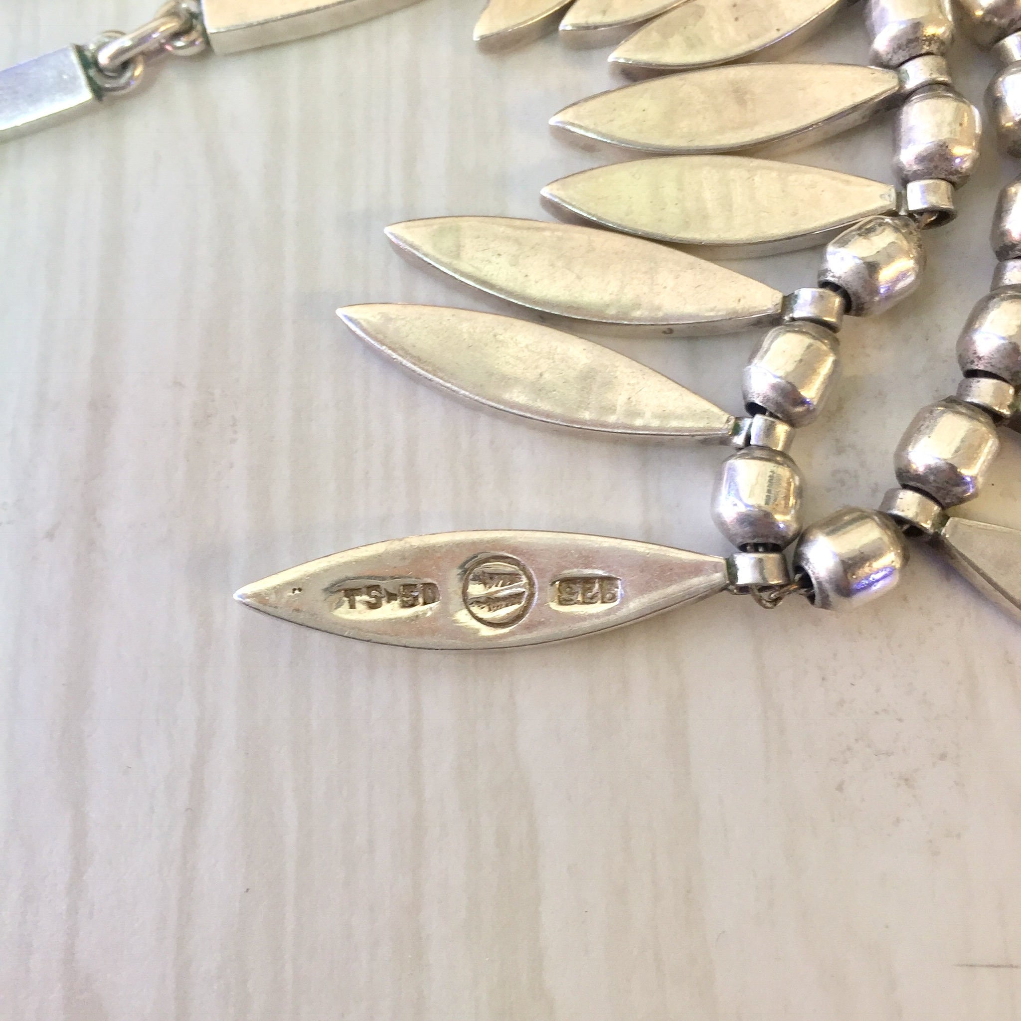 Vintage sterling silver statement necklace with layered dangling oval pendants, creating a bib-style design. Mexican jewelry piece that makes a bold fashion statement, perfect as a unique gift.