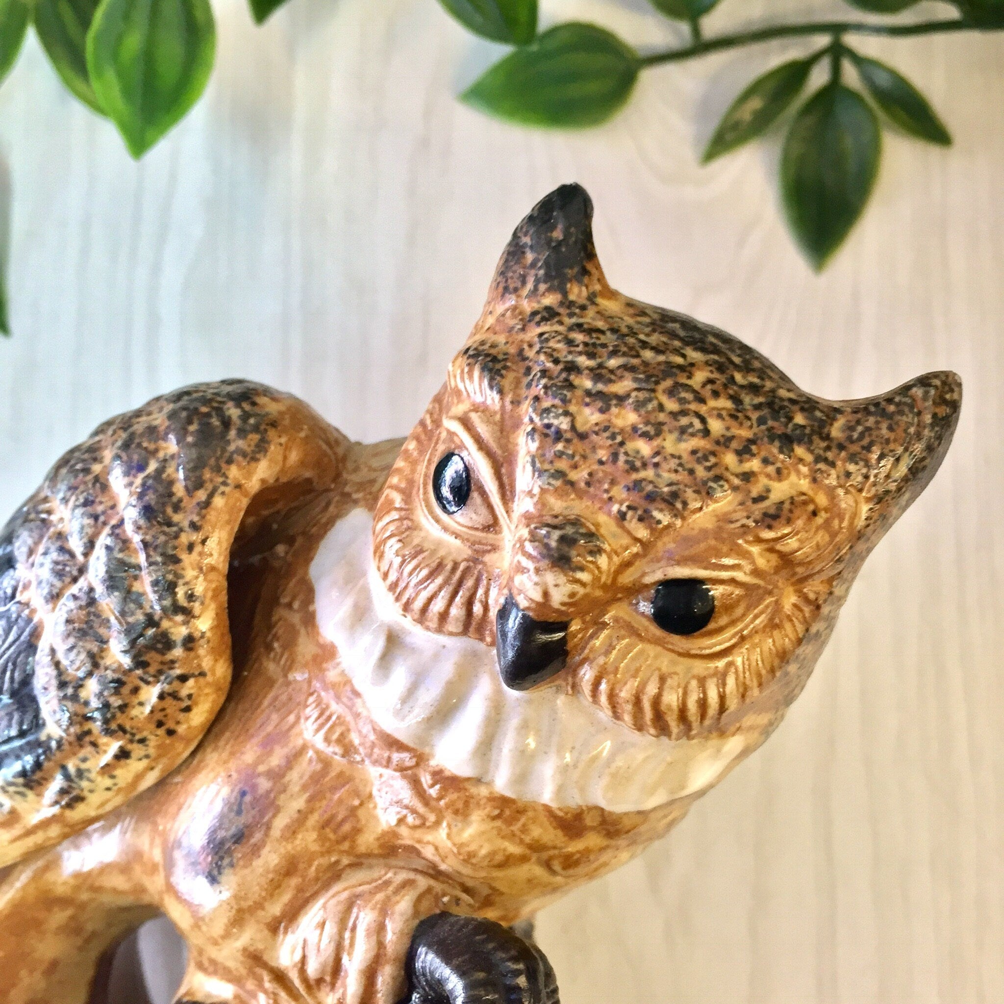 Vintage ceramic owl figurine with brown and black coloring, perched on a branch with leaves in the background, suitable for home decor or as a gift for Mother's Day.