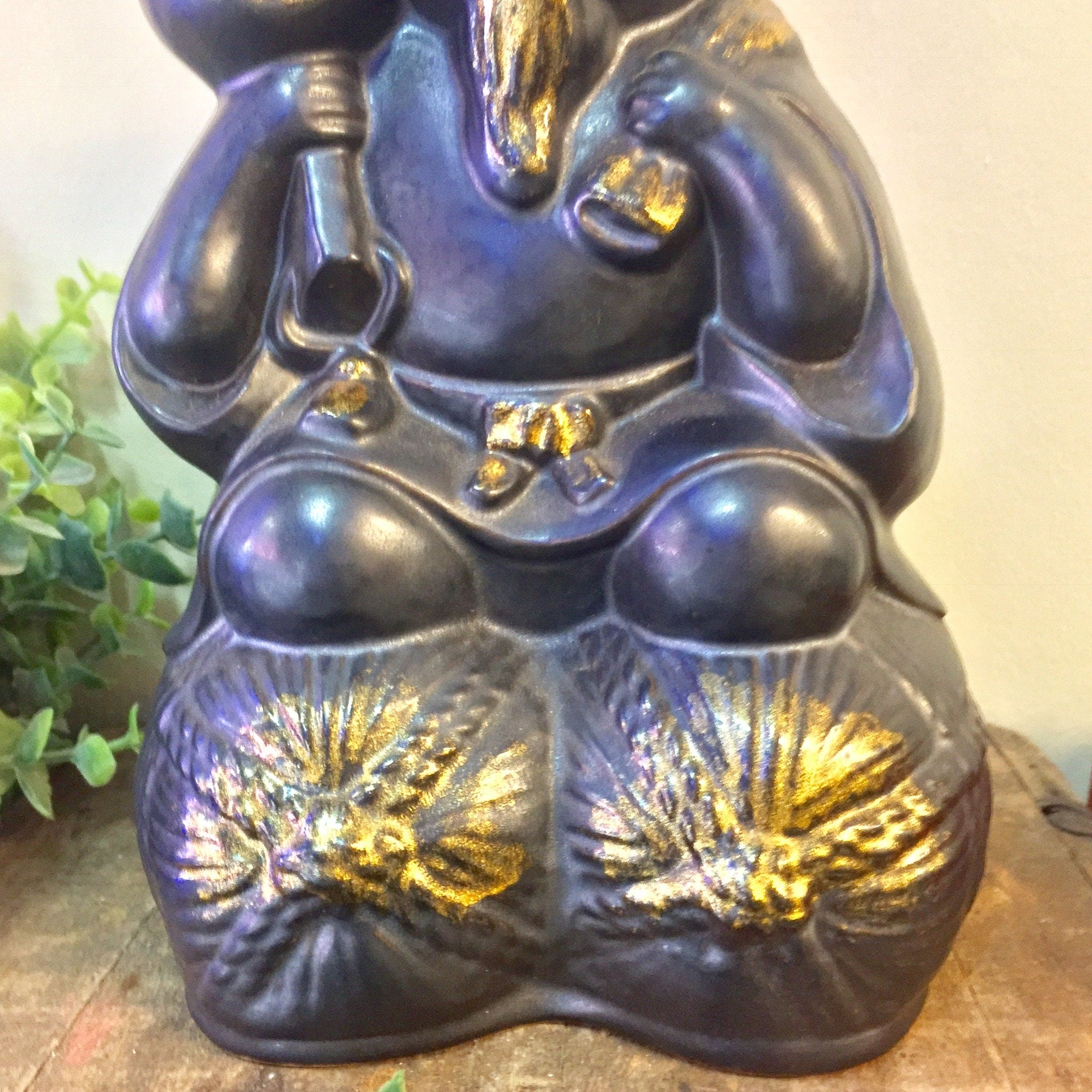 Large vintage black and gold ceramic sake bottle shaped like a sitting animal figure, possibly a rat or mouse, with gold accents on its feet, an intricate and unique Asian home decor piece