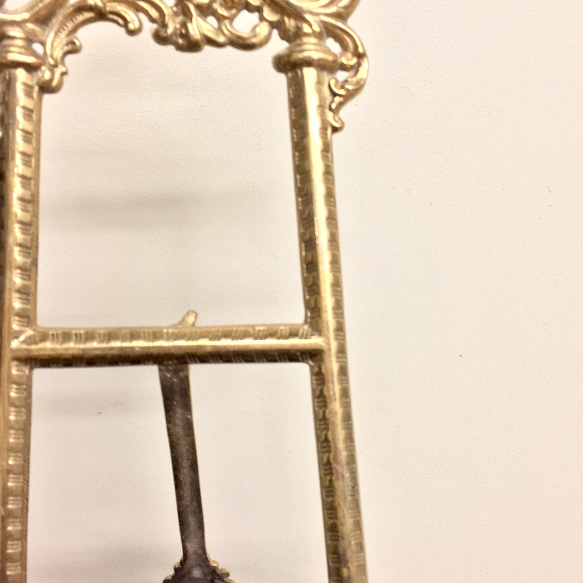 Vintage brass easel displaying ornate filigree design, suitable for use as a book holder, cookbook stand, or decorative frame in bohemian chic home decor.
