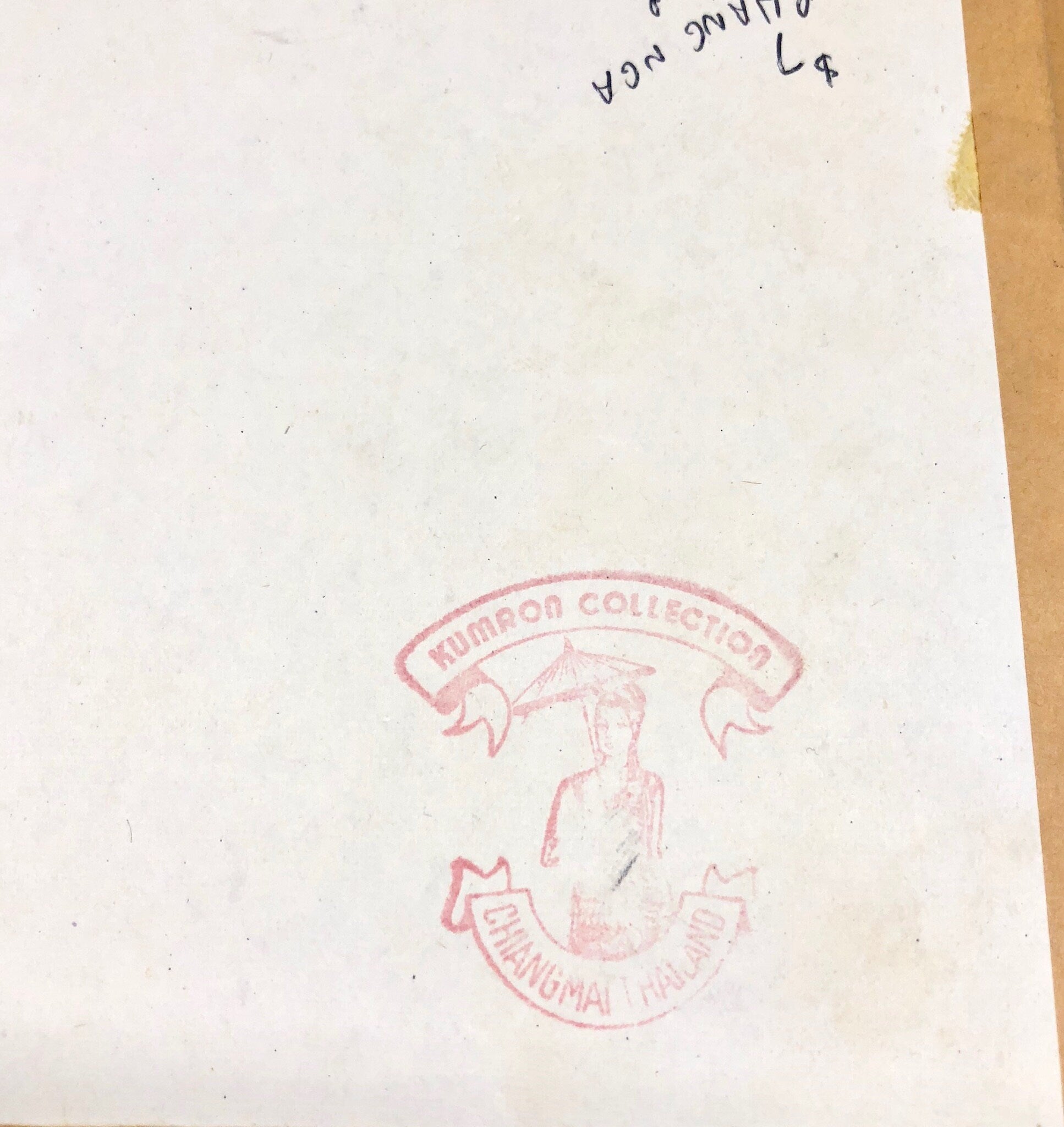 Pink round stamp with an illustrated human figure in the center and Thai text surrounding it on a slightly torn white paper background