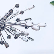Silver rhinestone floral spray brooch and clip-on earrings set from Marvella featuring white stones in an art deco style design.