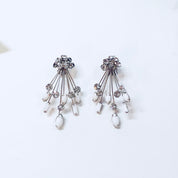Marvella silver tone clip-on earrings with clear rhinestones and matching Art Deco style brooch pin featuring white stones and dangling teardrops.