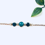 Vintage 14K gold link bracelet with blue and green natural iridescent stones, fine jewelry suitable for weddings.