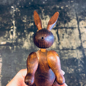 Wooden carved rabbit toy figurine held in hand, vintage collectible bunny animal decor