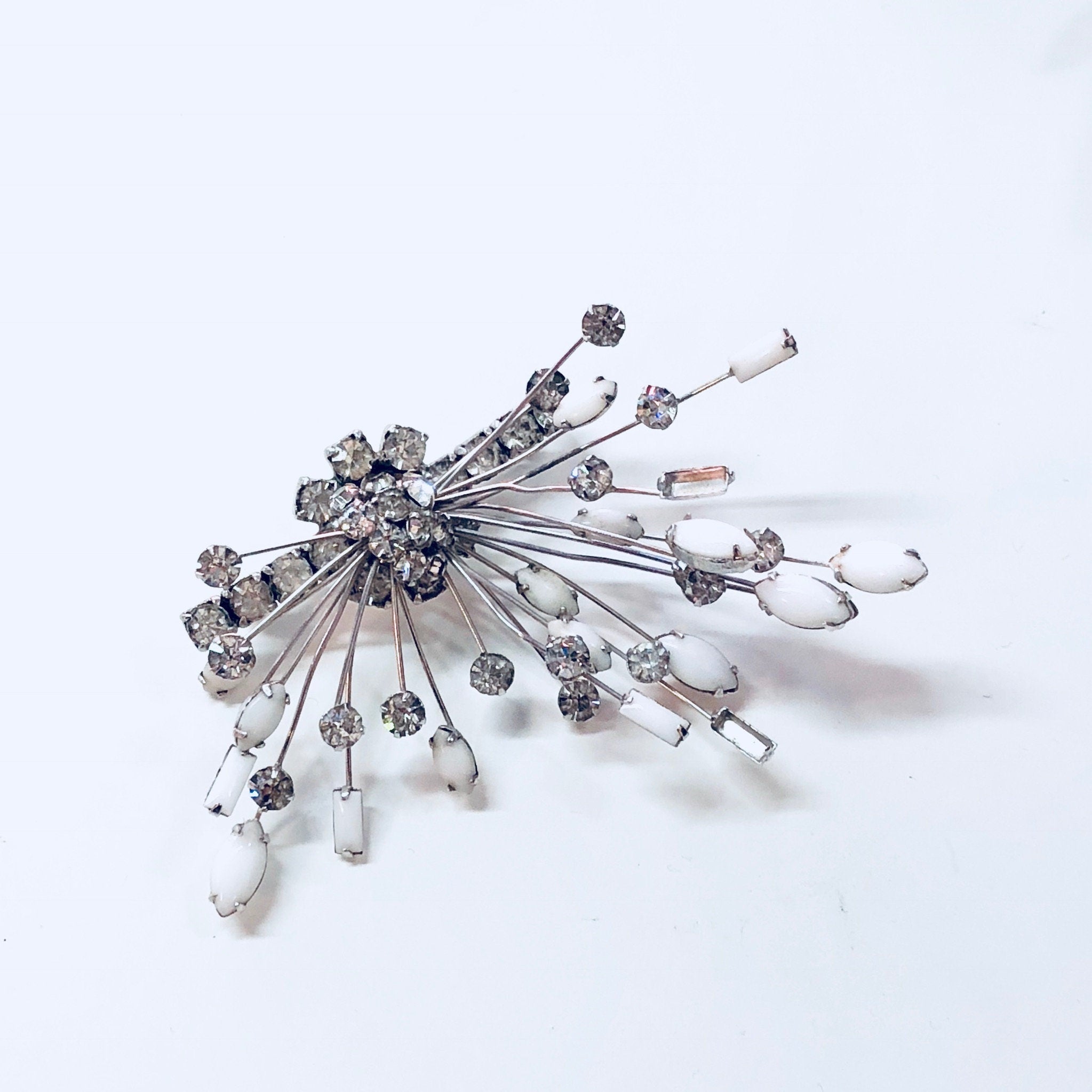 Marvella jewelry set with silver rhinestone brooch and unique clip-on earrings featuring white stones in an art deco style design