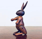 Vintage wooden rabbit toy carving with unique posture and detailing, collectible animal decor for home display.