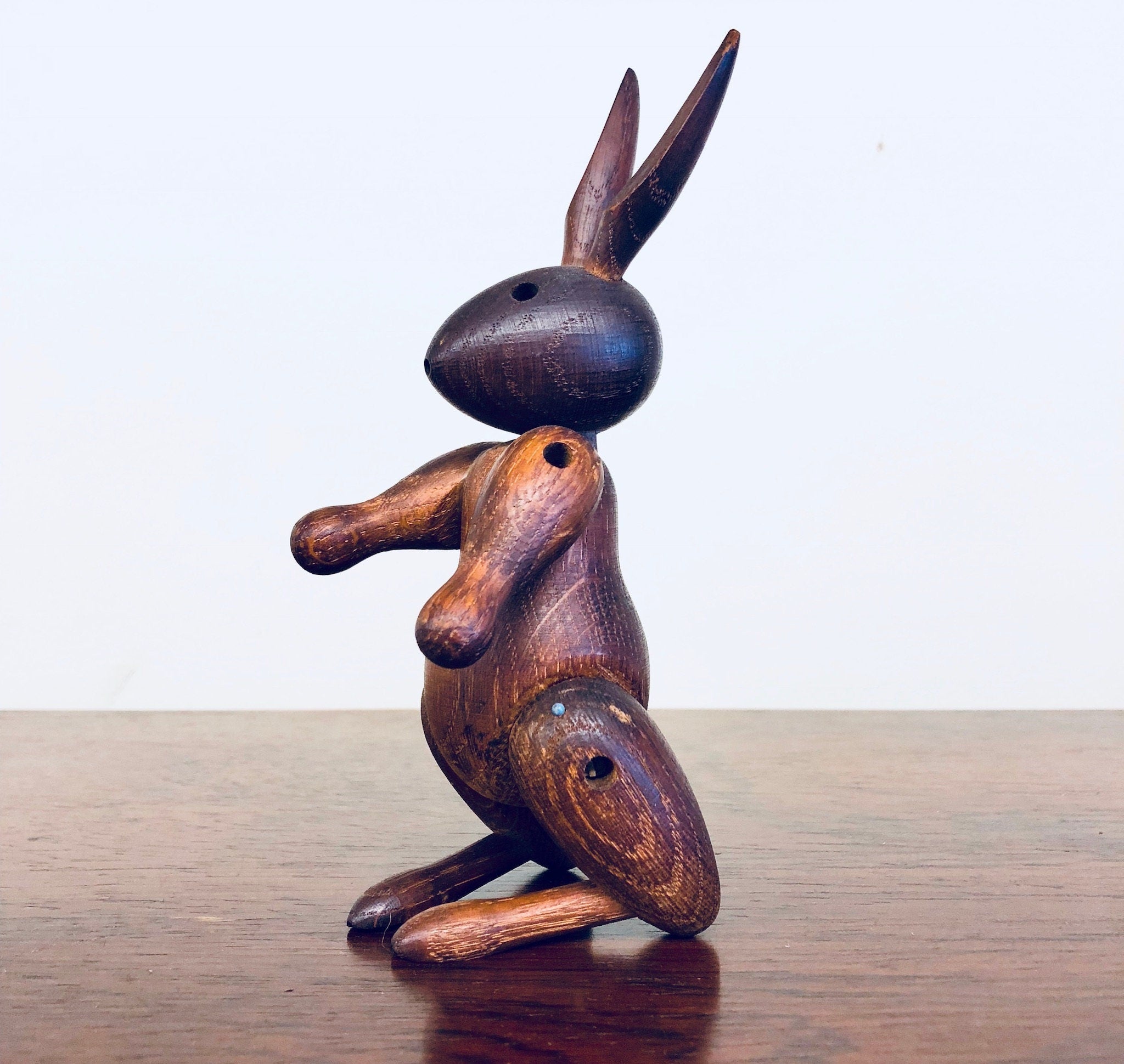 Vintage wooden rabbit toy carving with unique posture and detailing, collectible animal decor for home display.