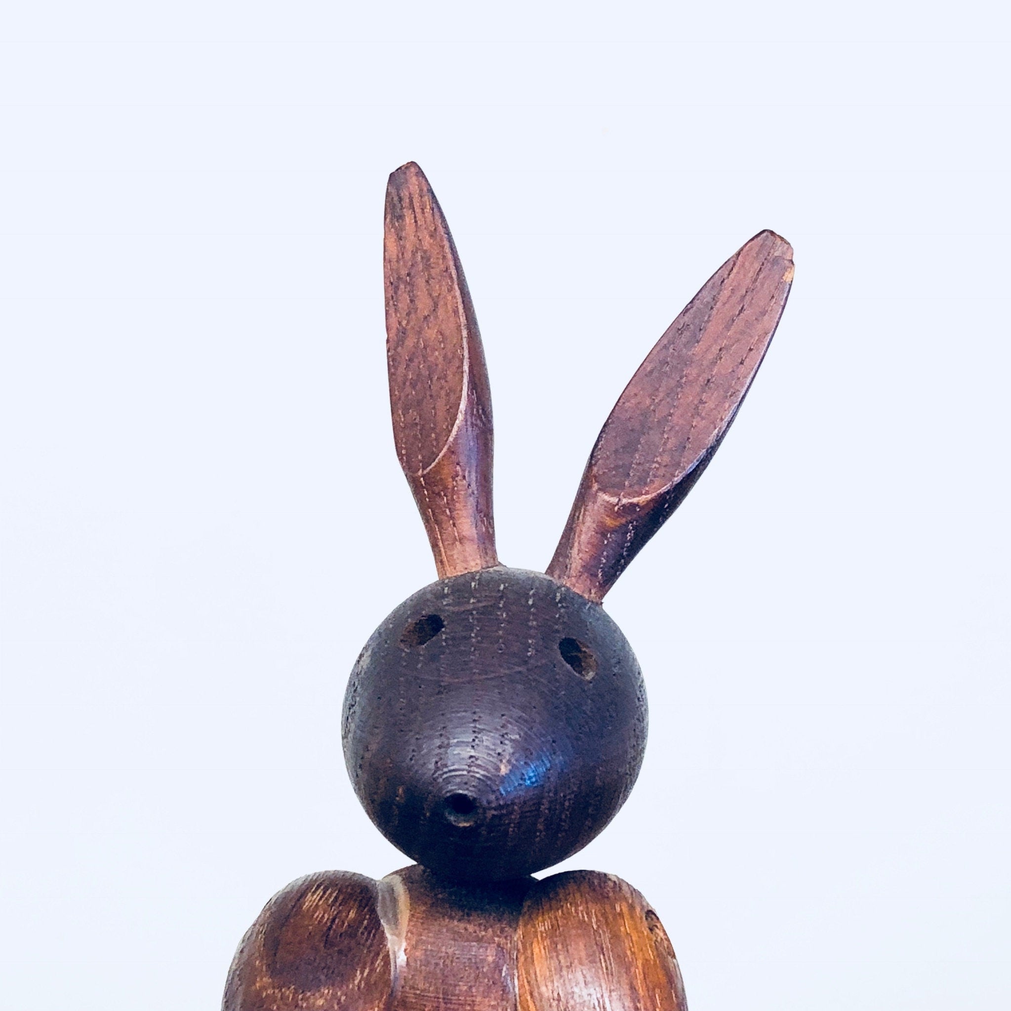 Vintage wooden rabbit toy carving with long ears and round body, handcrafted animal decor collectible