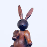 Vintage wooden rabbit toy carving with large ears and round head, collectible animal decor bunny figurine sculpture