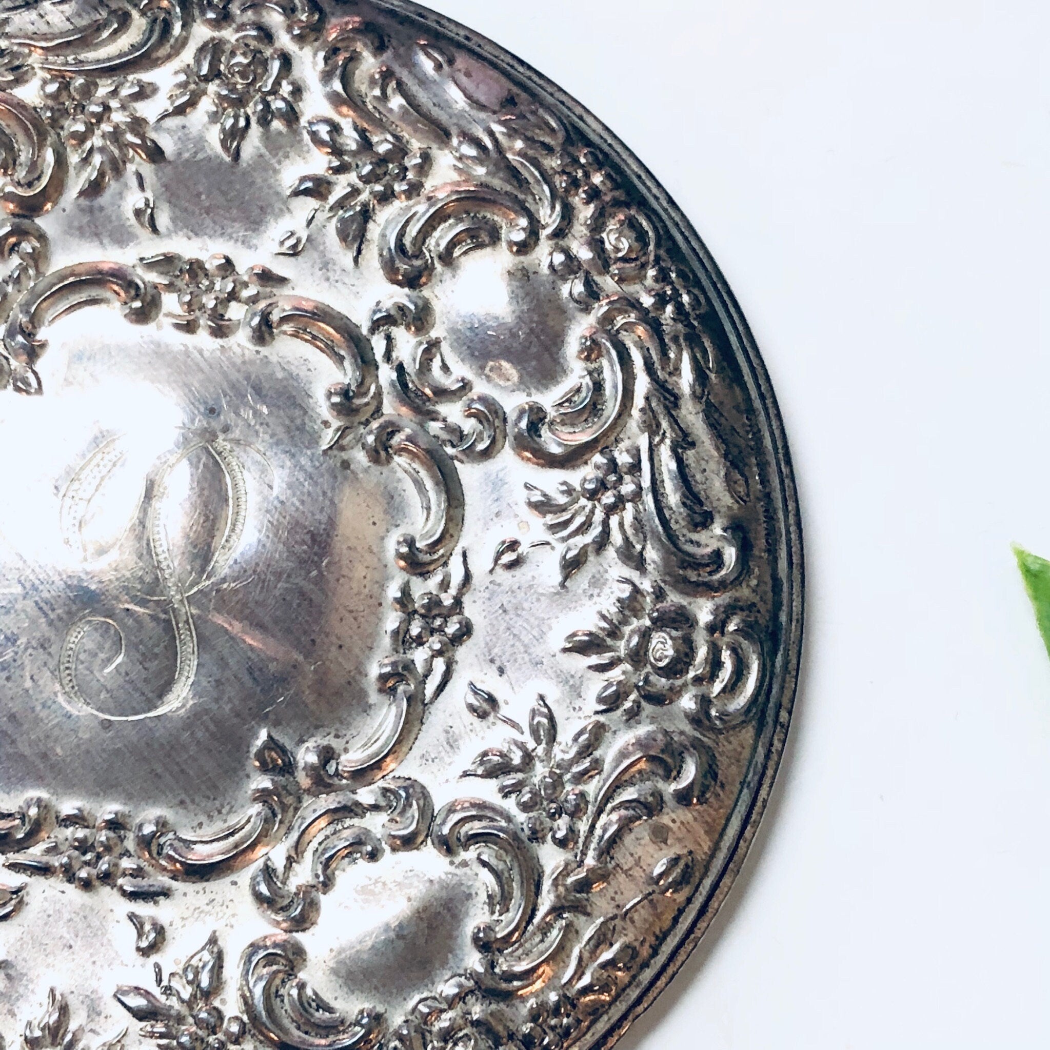 Ornate sterling silver vintage compact mirror with intricate floral and scroll engraving, made by Towle Silversmiths, featuring a monogram on the lid.
