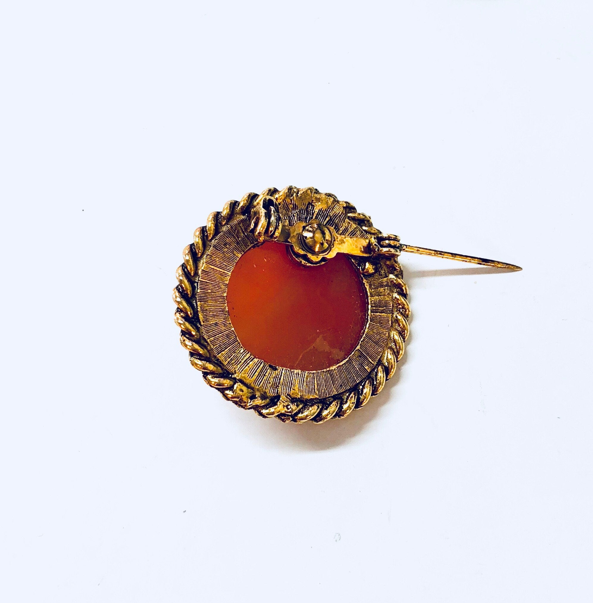Vintage gold-toned cameo brooch with orange and white round design, Victorian-style cameo jewelry pin
