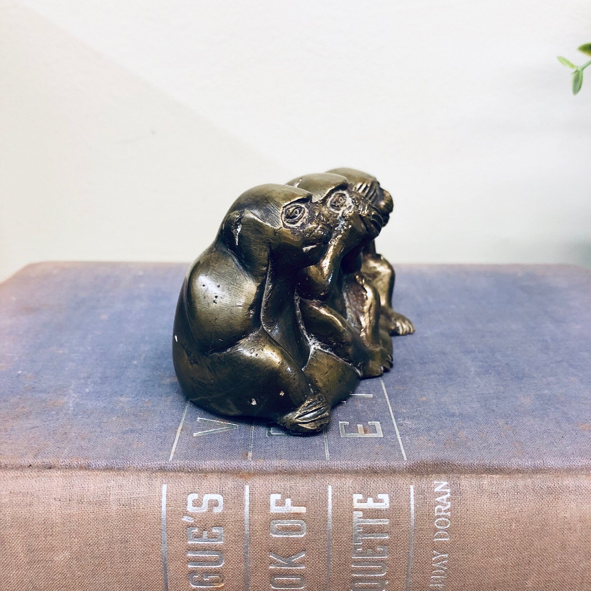 Brass figurine of three wise monkeys depicting "hear no evil, see no evil, speak no evil" on book, vintage home decor