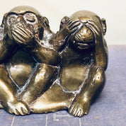 Three brass monkey figurines depicting "see no evil, hear no evil, speak no evil" pose, vintage home decor