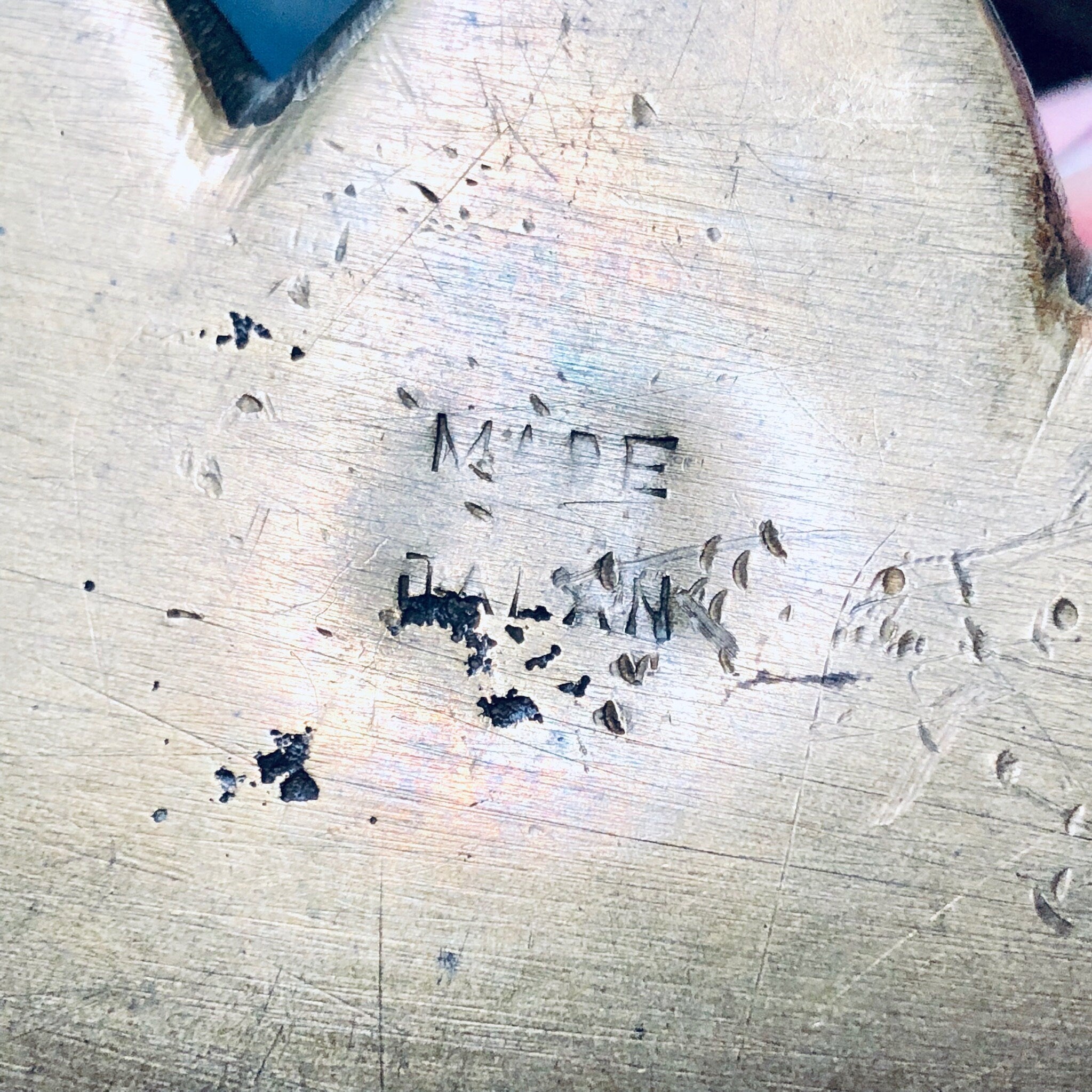 Carved text reading "Made in China" on worn wooden surface