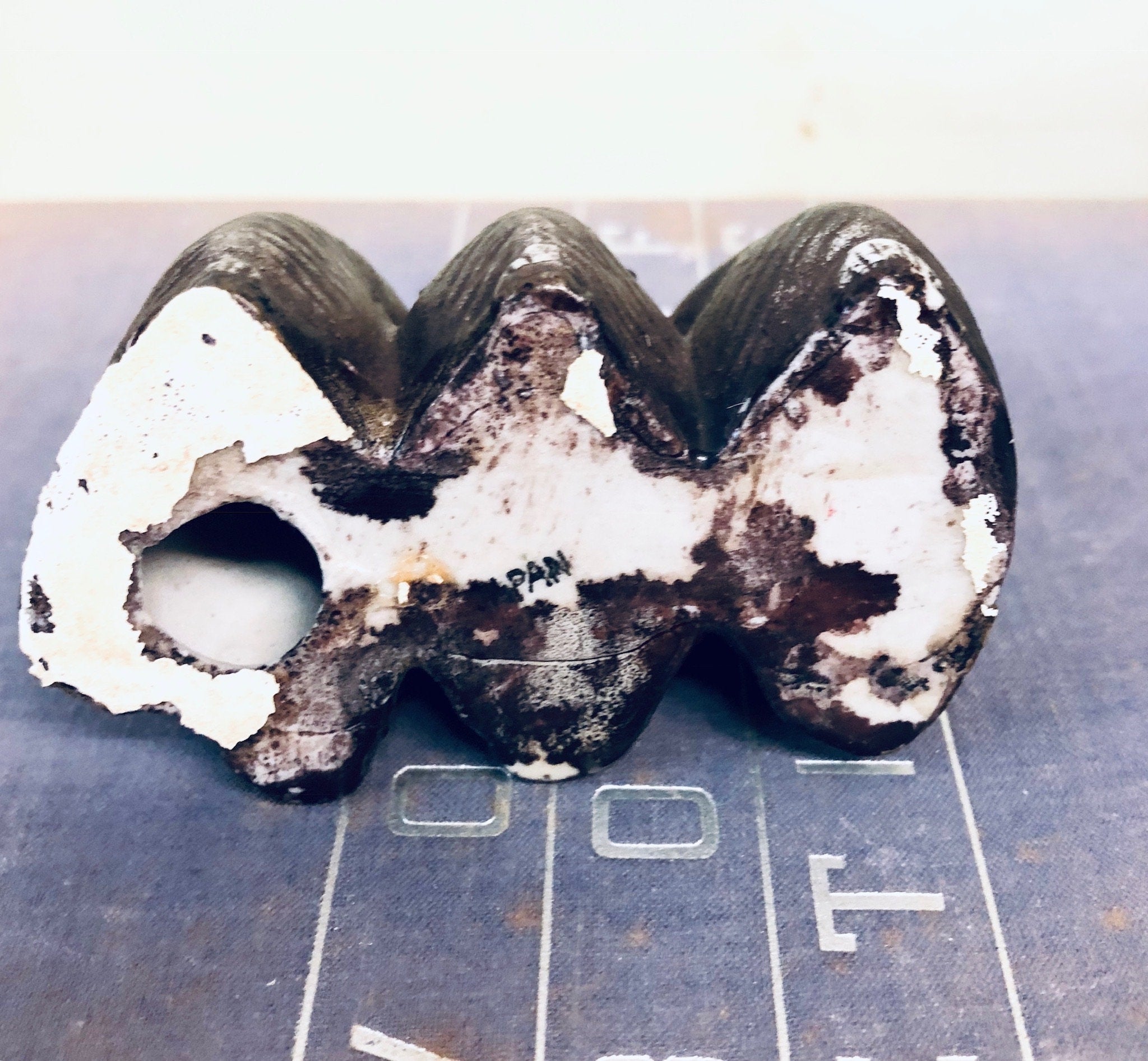 Three vintage ceramic monkey figurines depicting "see no evil, hear no evil, speak no evil" proverb, handmade in Japan, black and white coloring with distressed finish, decorative animal trinket for home decor.