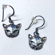 Silver cat mask dangle earrings featuring cut-out design depicting feline face with whiskers