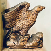 Vintage ceramic eagle bookends with gold tone finish, depicting two soaring birds, suitable for library or bookshelf decor.
