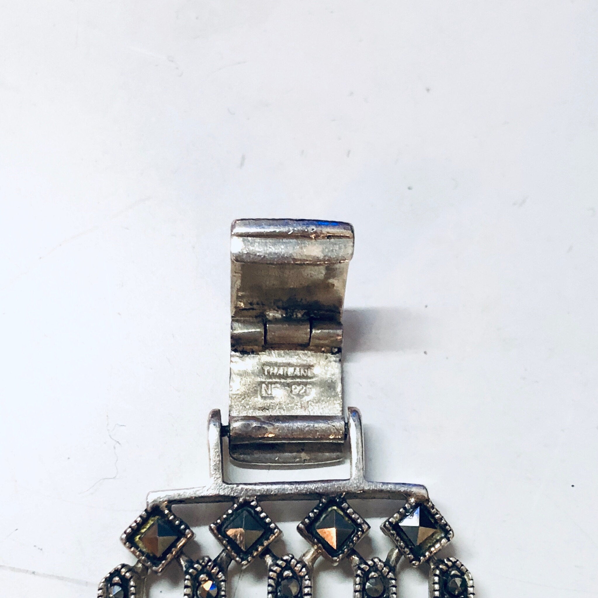 Vintage sterling silver link bracelet with marcasite stones on a white background