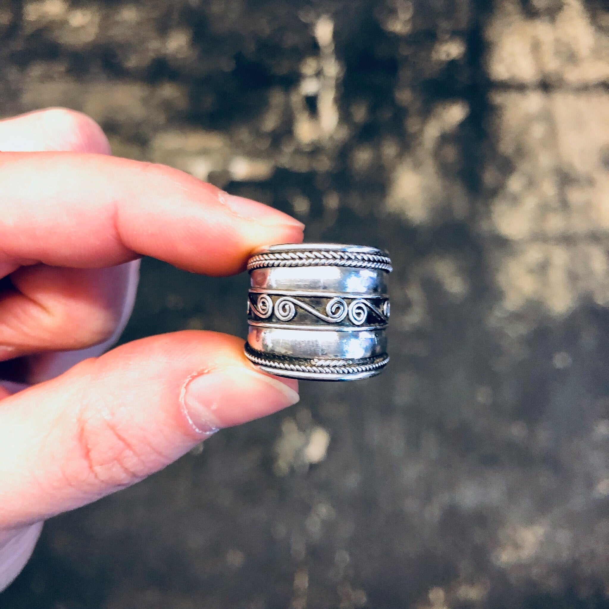 Vintage silver swirl band ring held between fingers, thick statement jewelry with simple swirl design, 925 silver ring gift for wife.