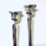 Vintage sterling silver candlesticks with a polished, shiny finish, suitable for home decor as a centerpiece or mantlepiece.