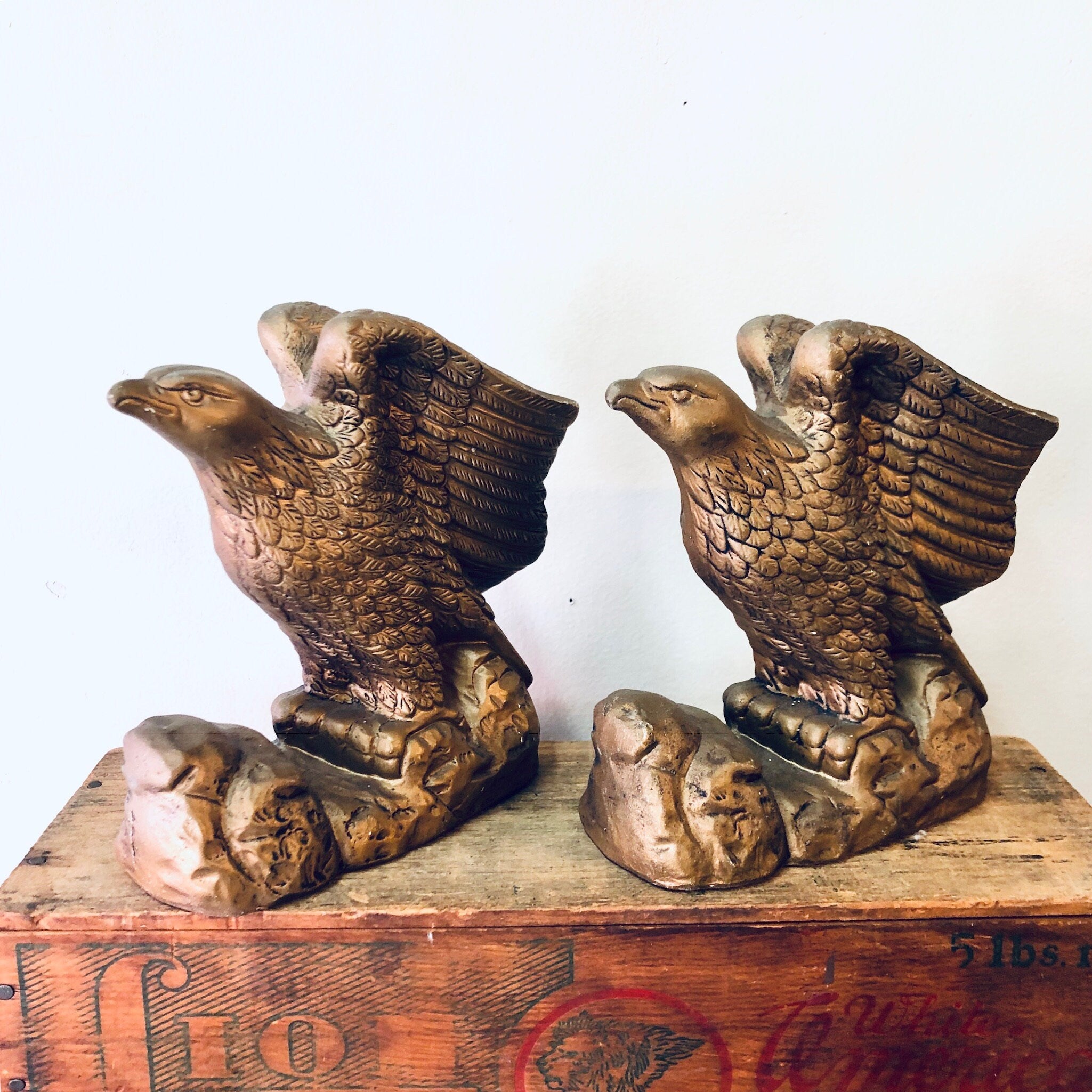 Vintage ceramic eagle bookends with a gold-toned finish, depicting majestic birds soaring. Perfect decor for a bookshelf or library.